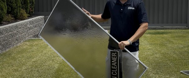 Silica technician washing a window screen on a XERO screen cleaner